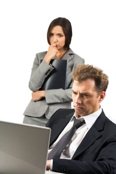 Photo of stressed businessman looking at laptop screen with scared woman at background