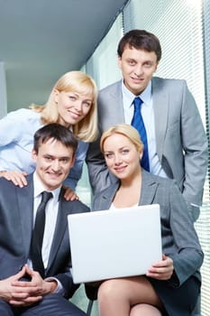 Portrait of four smiling confident business people