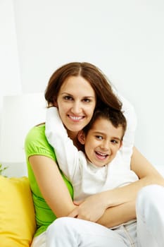 Family of happy mother and son looking at camera