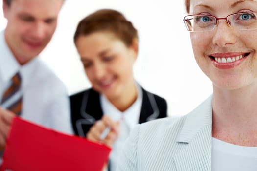 Female manager smiling against her two colleagues