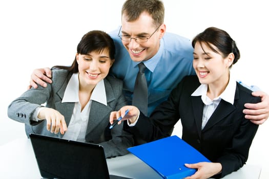 Photo of successful businesspeople looking at the laptop screen with smiles while two ladies pointing at it