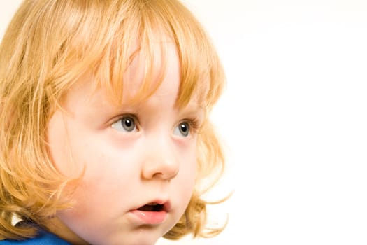 Face of little redhead girl looking at something over white background