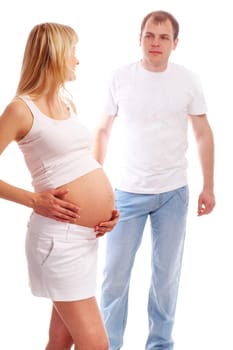 Image of pregnant woman touching her belly and looking at husband