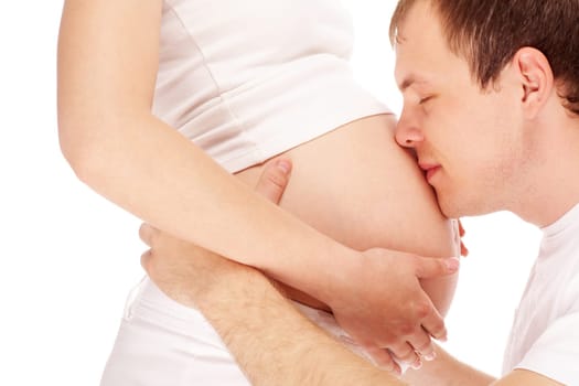 Image of happy man kissing pregnant belly of his wife