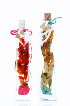 Fresh natural spa scene with herb essences in glass bottles,
