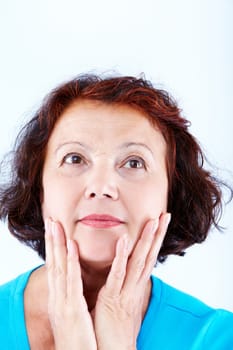 Portrait of serene middle-aged female touching her face