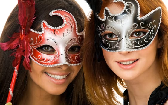 Portrait of two smart ladies in masks at masquerade