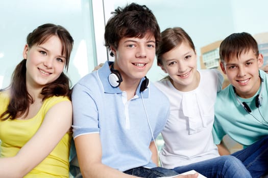 Portrait of four smiling teenagers looking at camera