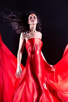 Portrait of charming female wearing elegant red dress