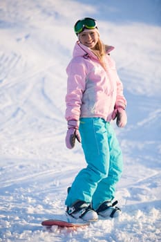 Image of happy girl on winter resort snowboarding there