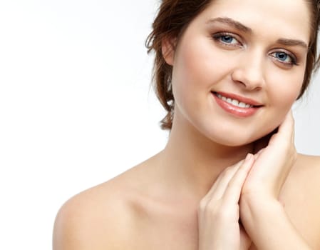 Portrait of charming girl touching her face and looking at camera