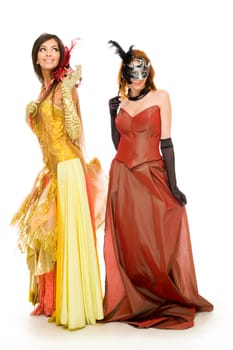 Portrait of charming females wearing elegant dresses during festival