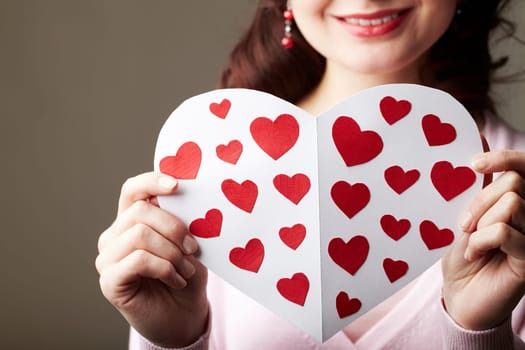 Close-up of female hands holding valentine card