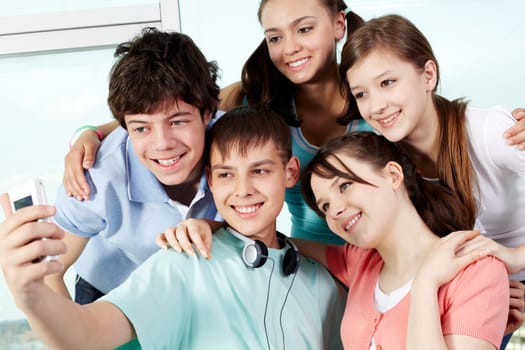 Five teenagers taking photo of themselves
