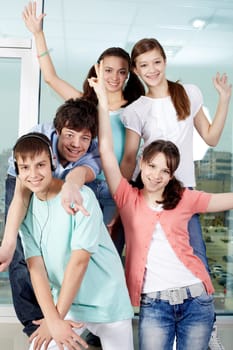 Five happy friends posing before camera