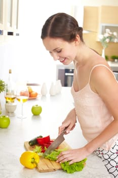 Portrait of happy female cooking vegetable salad