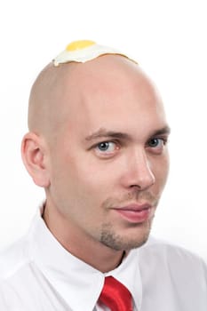 Image of handsome male with omelette on his bald head over white background
