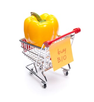 Buy bio products concept. Pepper in shopping cart with "buy bio"" note."