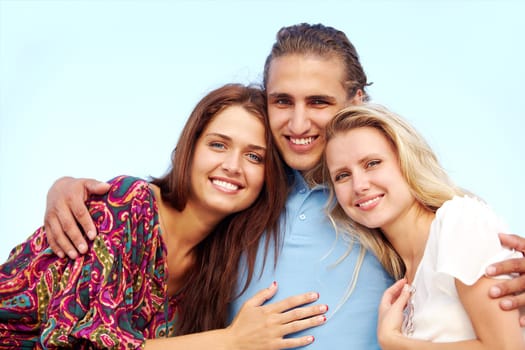 Portrait of happy girls and guy looking at camera with smiles