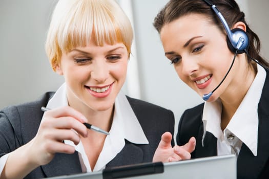 Portrait of two attractive business women working together