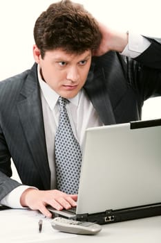 Portrait of smart businessman looking at laptop monitor with astonishment