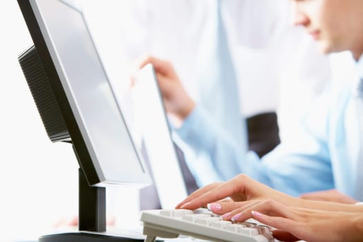 Close-up of female hands typing a letter at workplace