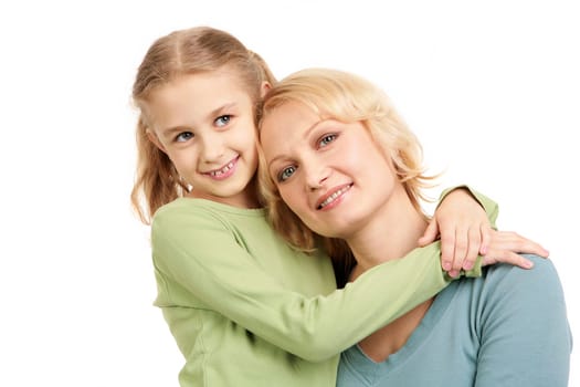 Portrait of little girl embracing woman wearing casual clothes