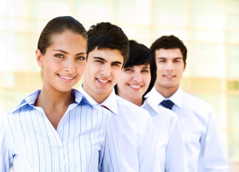 Portrait of attractive leader of friendly business group standing in line behind