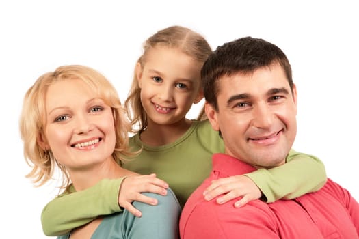 Portrait of happy parents being embraced by their daughter