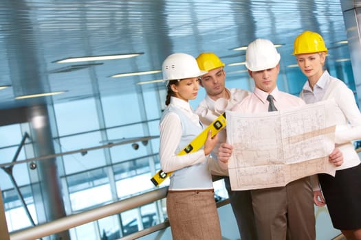 Four young architects examining a housing plan
