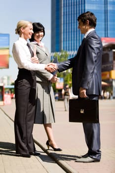 Photo of successful business partners handshaking after signing contract outdoors