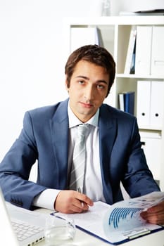 Portrait of a successful employer looking at camera while working
