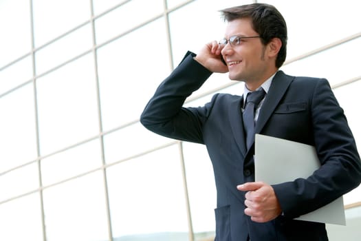 Portrait of confident businessman communicating by phone