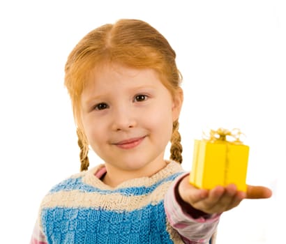 Pretty child holding small giftbox on her palm while stretching it to you