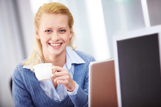 Portrait of successful business lady with cup looking at camera