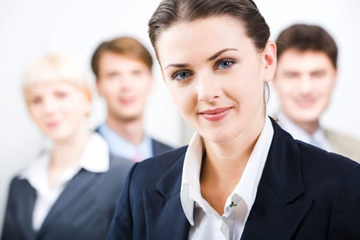 Photo of leader with her business team in the office