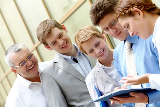 Image of business team looking at paper in male hands at meeting