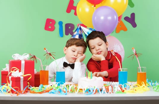 Portrait of two boys boring during birthday party