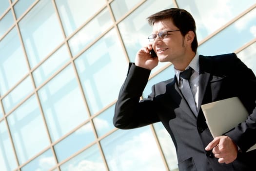 Portrait of businessman in suit calling by phone