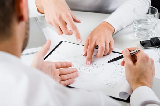 Womans hands pointing on the resources of new project