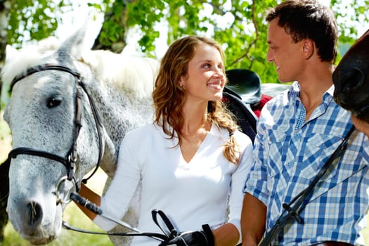 Image of happy couple of jockeys looking at each other