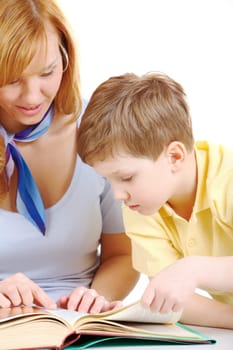 Photo of cute preschooler and his mother looking into book