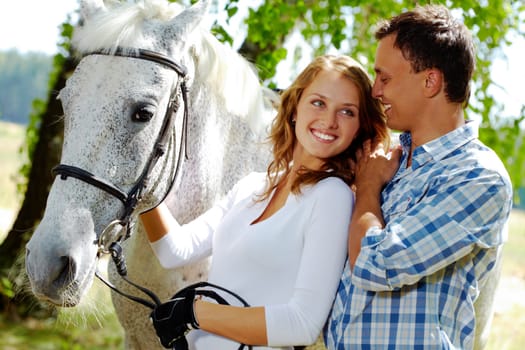 Image of happy woman with purebred horse and her sweetheart near by