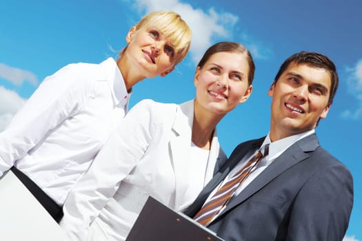 Portrait of confident business people on background of cloudy sky