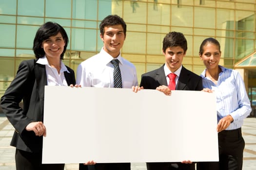 Portrait of team of people holding a paper outdoor