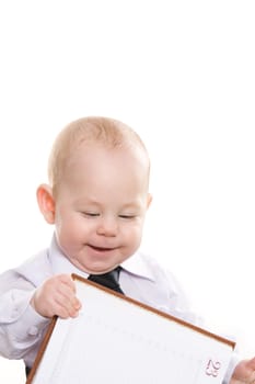 Portrait of baby boy holding open notepad over white background