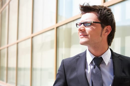 Portrait of confident businessman on background of modern building