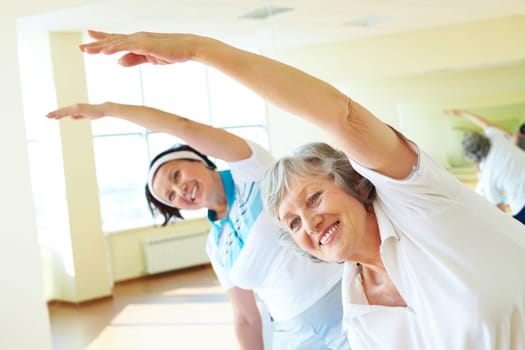 Portrait of sporty females doing physical exercise in sport gym