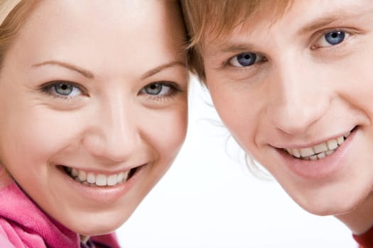 Happy faces of young girl and guy looking at camera and smiling