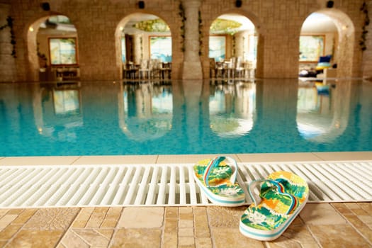 Photo of flip flops in swimming pool